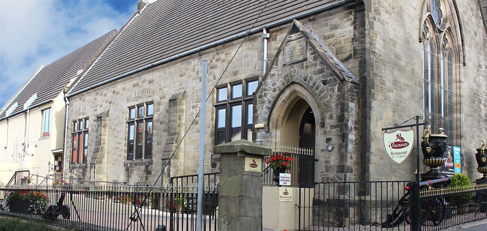 The stone frontage of Viscounts, a former church hall on Northland Row