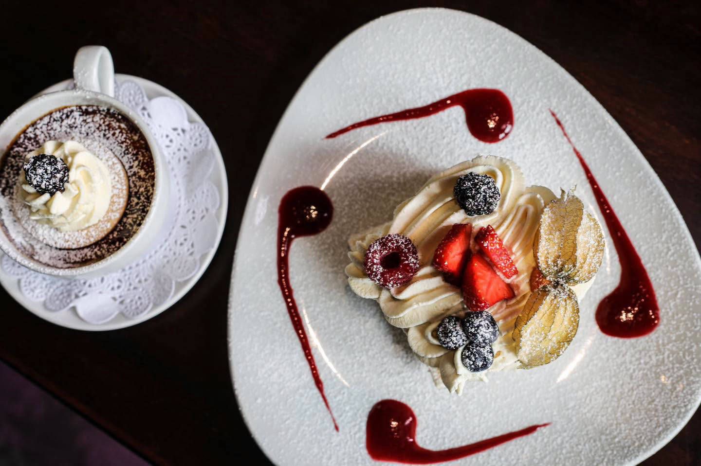Plated dessert with fresh berries and raspberry coulis